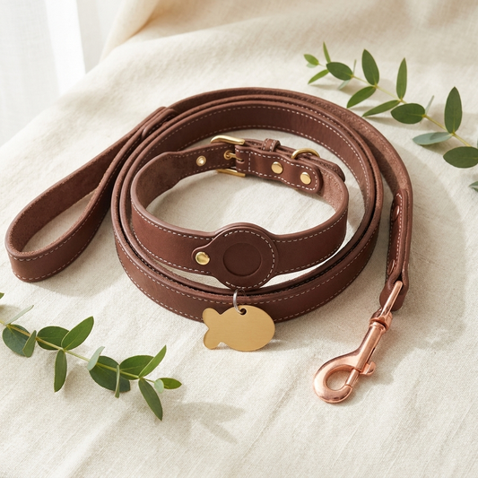 The Complete Set — Furmonogram brown leather collar, matching leash and gold engraved pet ID tag on cream linen